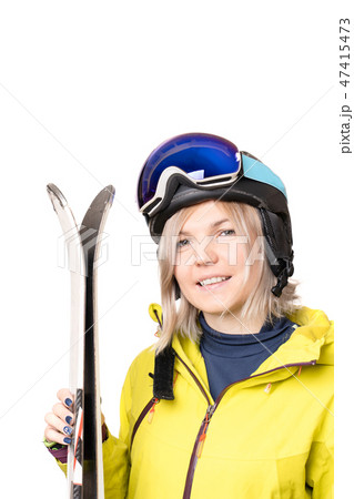 Smiling girl in helmet holding skis Smiling girl in helmet holding skis 47415473