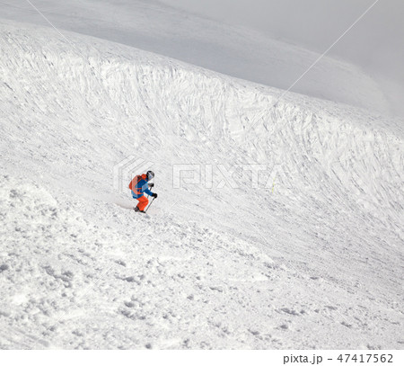 Skier downhill on freeriding slope and misty sky Skier downhill on freeriding slope and misty sky 47417562