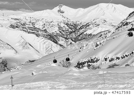 Snow-covered ski slope in snowy mountains  47417593
