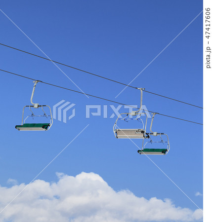 Sunlight chair-lift and blue sky with clouds 47417606