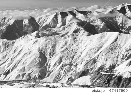 Speed flying at snowy mountains over ski resort Speed flying at snowy mountains over ski resort 47417609