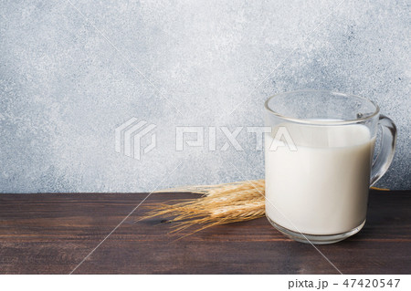 Glass of milk and wheat branches on rustic Glass of milk and wheat branches on rustic 47420547