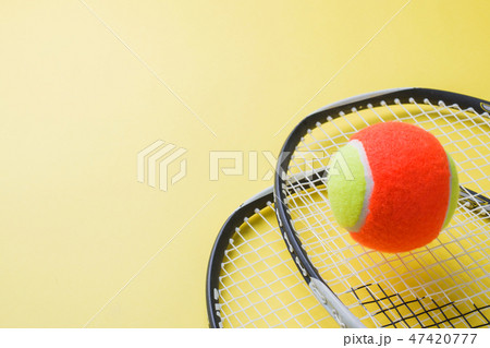 Tennis Ball and rackets on yellow Background,  47420777