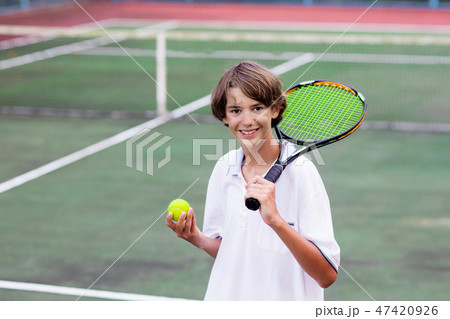 Child playing tennis on outdoor court Child playing tennis on outdoor court 47420926