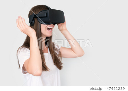 Young woman wearing virtual reality goggles headset, vr box. Connection, technology, new generation 47421229