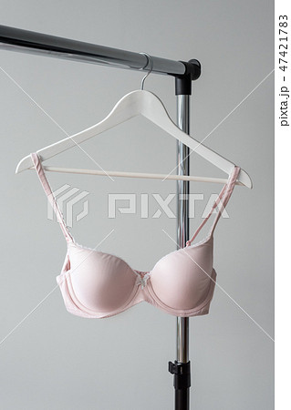Pink bra hanging on a hanger. Textile, Underwear. Female bra in lingerie underwear store. Advertise 47421783