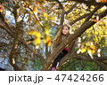 A pretty girl sitting on a tree in early spring 47424266
