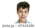 The boy smiles and shows the upper braces on teeth 47424286
