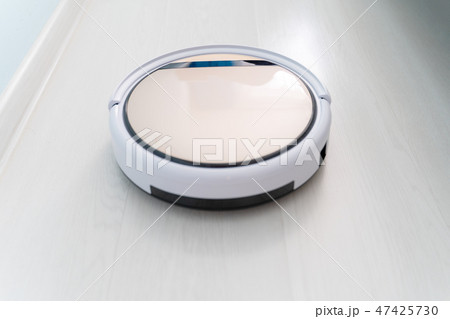 Robotic vacuum cleaner cleaning laminate wood floor. Robotic vacuum cleaner cleaning laminate wood floor. 47425730