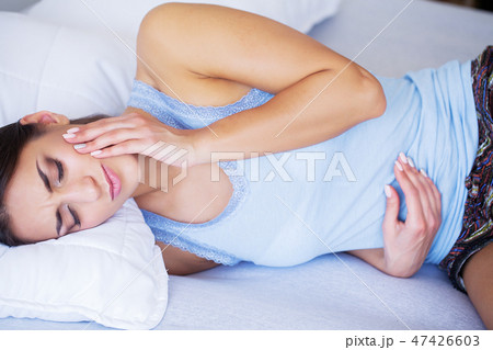 Tooth Pain. Woman Feeling Tooth Pain. Closeup Of Beautiful Sad Girl Suffering From Strong Tooth Pain Tooth Pain. Woman Feeling Tooth Pain. Closeup Of Beautiful Sad Girl Suffering From Strong Tooth Pain 47426603