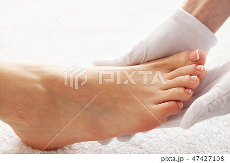 Pedicure day. Master using professional instruments when doing pedicure. Pedicure day. Master using professional instruments when doing pedicure. 47427108