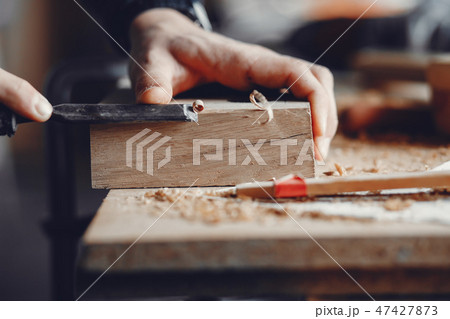 The carpenter works with a tree 47427873