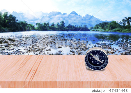 Old compass on wood walk and river with blue sky. Old compass on wood walk and river with blue sky. 47434448