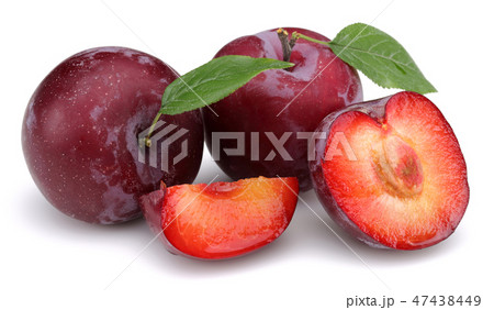 Red plums with leaves on white background 47438449