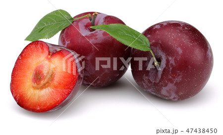 Red plums with leaves on white background Red plums with leaves on white background 47438450