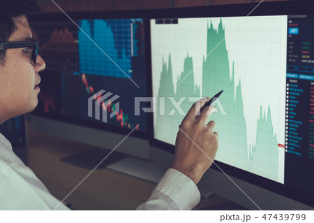Young businessman hand pointing to stock market 47439799