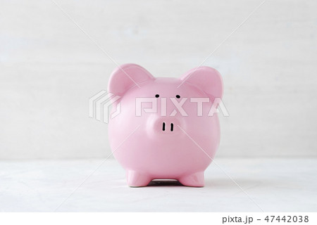 Pink piggy bank over a light off white background 47442038