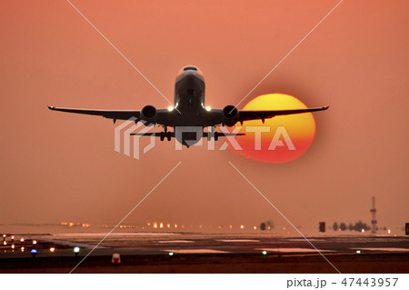 美しい夕焼けと夕陽を背景に離陸する飛行機風景(阿蘇くまもと空港) 47443957