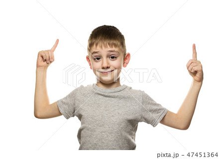 Smiling fair-haired boy in a gray T-shirt stands 47451364