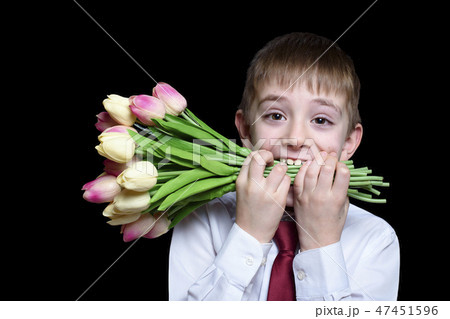 Boy in shirt and tie holding a bouquet of tulips Boy in shirt and tie holding a bouquet of tulips 47451596