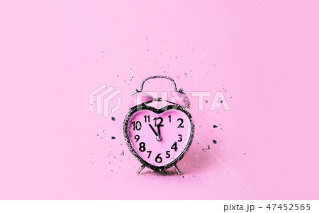 Heart shaped clock on pink background. Heart shaped clock on pink background. 47452565