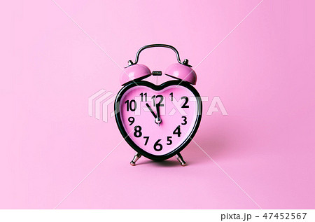Heart shaped clock on pink background. Heart shaped clock on pink background. 47452567