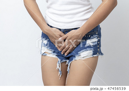 Close up woman used her hands to cover her crotch 47456539