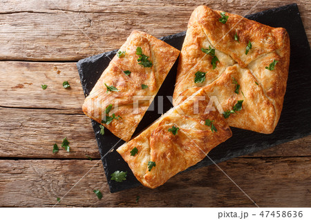 Delicious Khachapuri stuffed with Suluguni cheese Delicious Khachapuri stuffed with Suluguni cheese 47458636