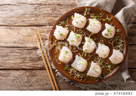 Chinese dim sum with shrimp served with microgreen Chinese dim sum with shrimp served with microgreen 47458992