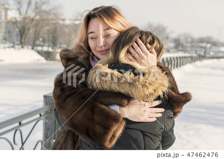 two hugging women in winter 47462476