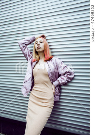 young pretty fashion dressed blong teenage girl posing friendly street style, lifestyle people 47469252