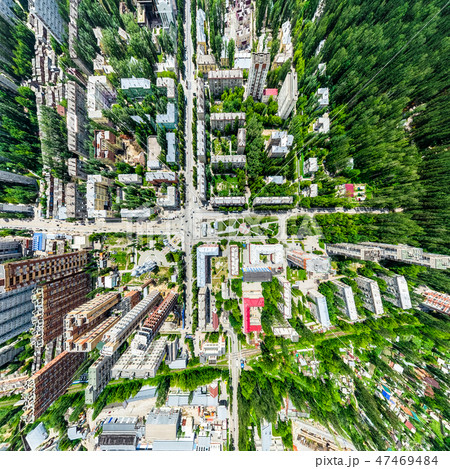 Aerial city view with crossroads and roads, houses, buildings, parks and parking lots. Sunny summer 47469484