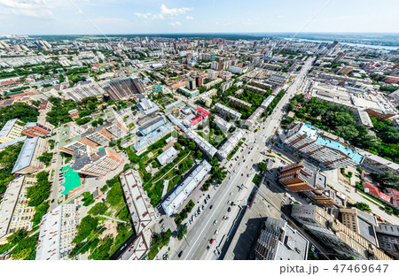 Aerial city view with crossroads and roads, houses, buildings, parks and parking lots. Sunny summer Aerial city view with crossroads and roads, houses, buildings, parks and parking lots. Sunny summer 47469647