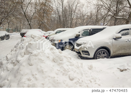 Snow covered ows of cars in the parking lot. 47470485
