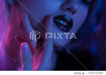 Makeup with red lips. Touching red lips 47473397
