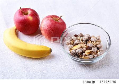 Healthy breakfast with banana, apple and Fresh granola, muesli in bowl on textile background. Top 47475196