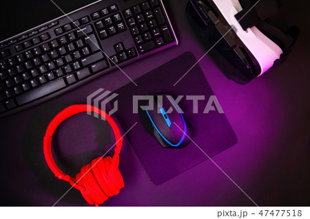 Top view a gaming gear, mouse, keyboard, joystick, headset, VR Headset on black table background. Top view a gaming gear, mouse, keyboard, joystick, headset, VR Headset on black table background. 47477518