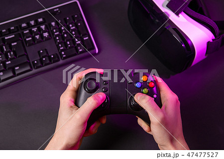 Man hands playing a computer game with a game joystick. 47477527