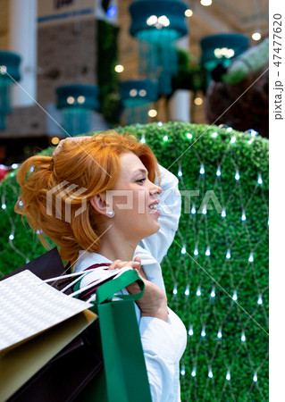 Young Women with Packages Shopping in Modern Mall. Shopping Concept. Black Friday Concept. Happy Young Women with Packages Shopping in Modern Mall. Shopping Concept. Black Friday Concept. Happy 47477620