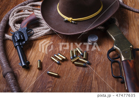 Wild west guns, ammunition and silver dollars 47477635