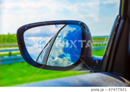 Landscape in the sideview mirror of a car 47477921