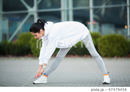 Fitness. Beautiful young woman exercising in the park - Sport and healthy lifestyle concept 47479456