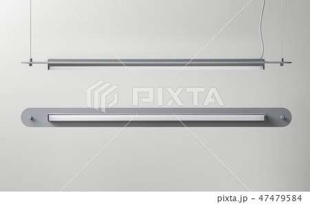 Gray metal lamps hanging on light wall background in studio 47479584