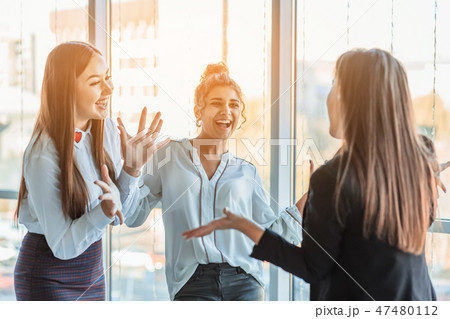 Three businesswomen working in the office. Positive workplace concept. Three businesswomen working in the office. Positive workplace concept. 47480112
