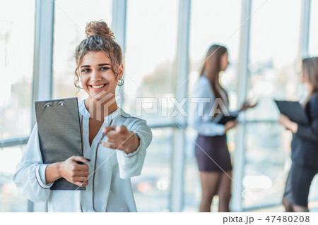 Business lady at the office talking to a smartphone. Happy smiling Caucasian business woman busy Business lady at the office talking to a smartphone. Happy smiling Caucasian business woman busy 47480208