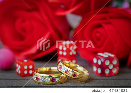 Wedding rings with dice and red roses Wedding rings with dice and red roses 47484821