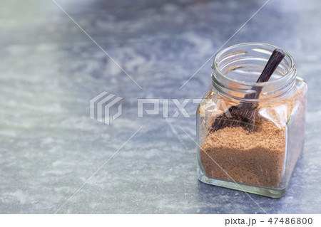 Brown sugar with wooden spoon in glass bottle. Brown sugar with wooden spoon in glass bottle. 47486800