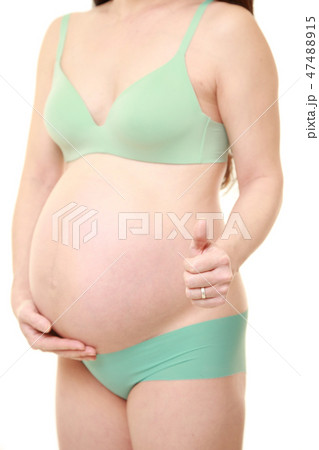 Pregnant woman in underwear with a thumb up - Stock Photo [47488915] - PIXTA