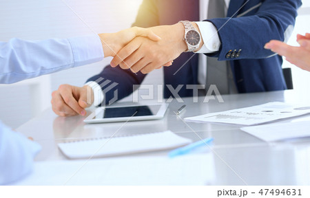 Group of business people or lawyers shaking hands finishing up a meeting , close-up. Success at 47494631