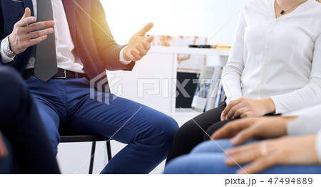 Group of people sitting in a circle during therapy. Meeting of business team participating in Group of people sitting in a circle during therapy. Meeting of business team participating in 47494889